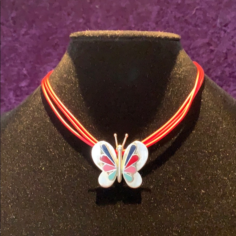 Elegant butterfly pendant with rubber chain.